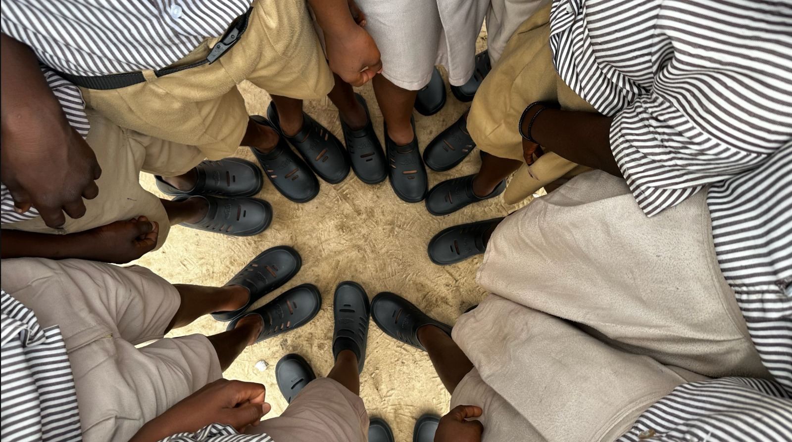 Children wearing donated shoes